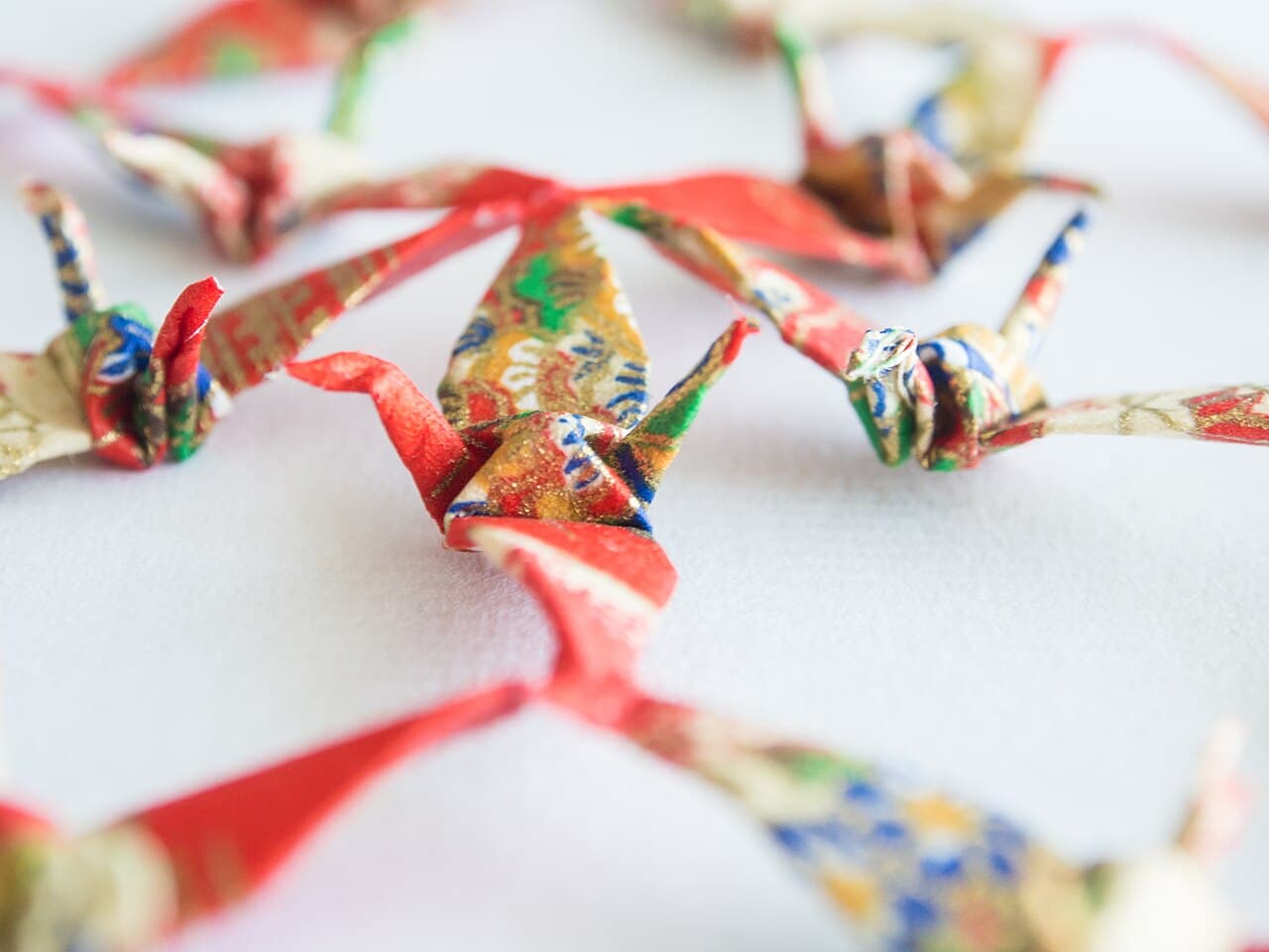 Colorful hand-folded origami paper cranes (senbazuru), a traditional Japanese craft