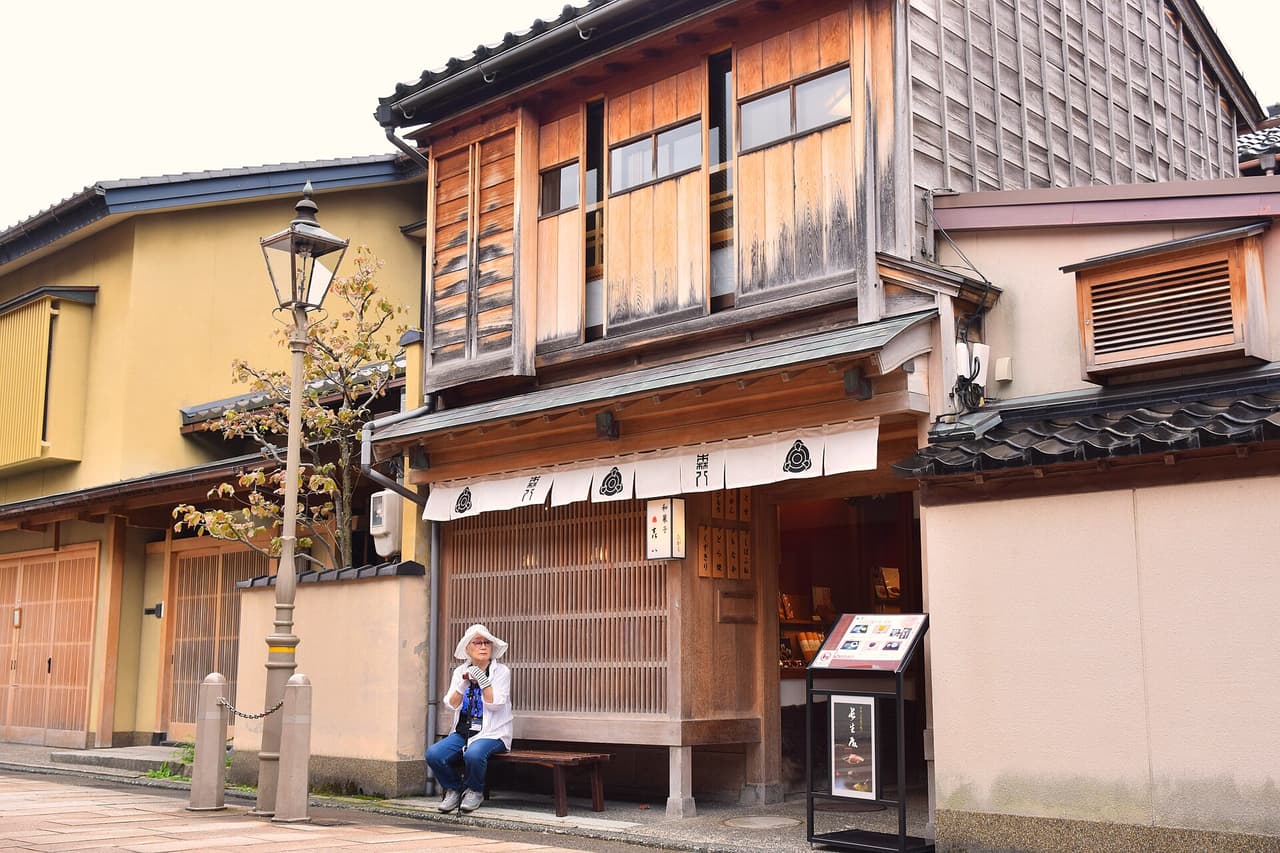 Wooden latticed teahouse facades along a street in the Higashi Chaya district, Kanazawa