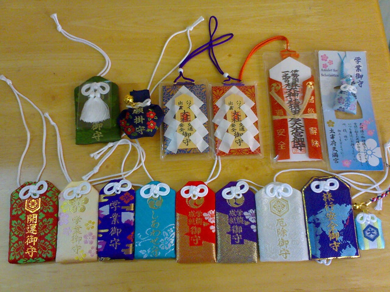A collection of Japanese omamori amulets in embroidered brocade pouches