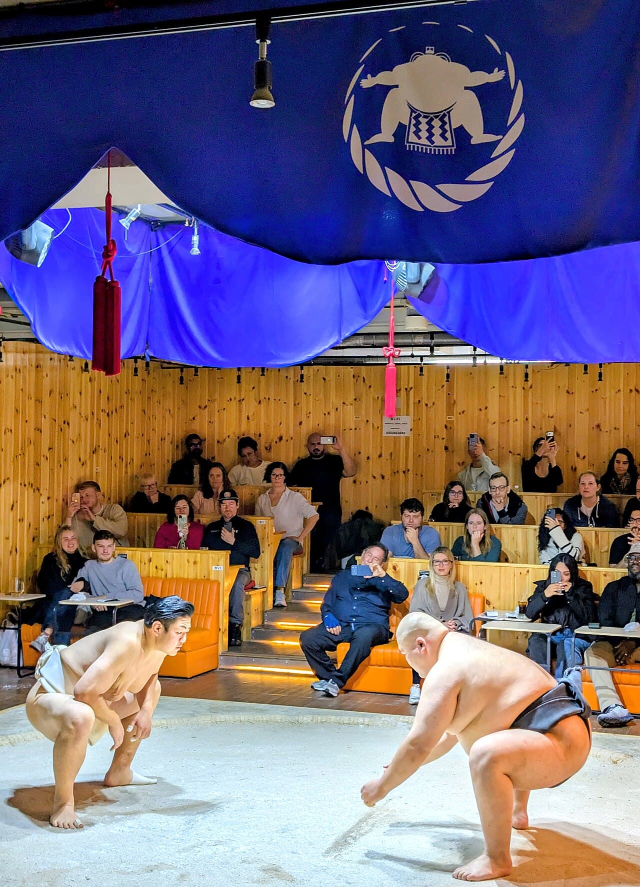 A sumo wrestling demonstration in the ring at a Tokyo sumo experience show