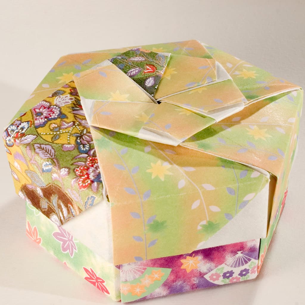 A decorative hexagonal origami gift box with its lid on, a Japanese paper-folding style used for gift presentation