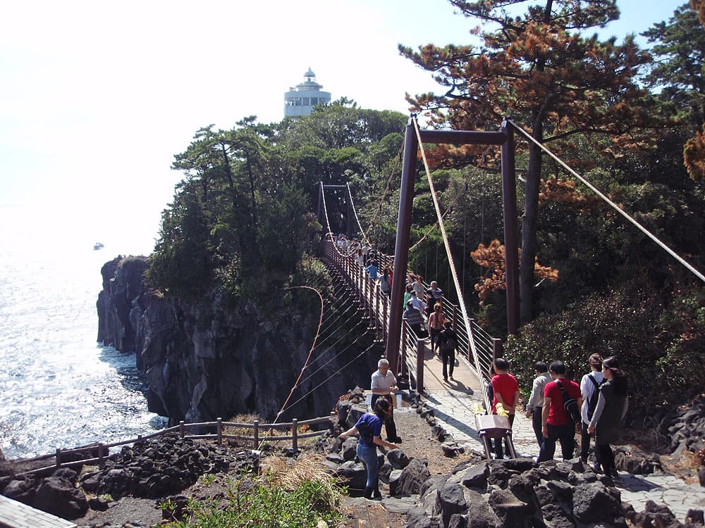 静岡県伊東市・城ヶ崎海岸。溶岩の断崖に架かる門脇つり橋と、その先の門脇埼灯台